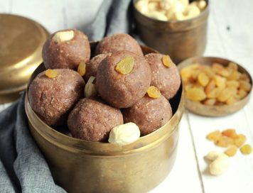 Finger millet (Ragi) laddu displayed in a copper vessel